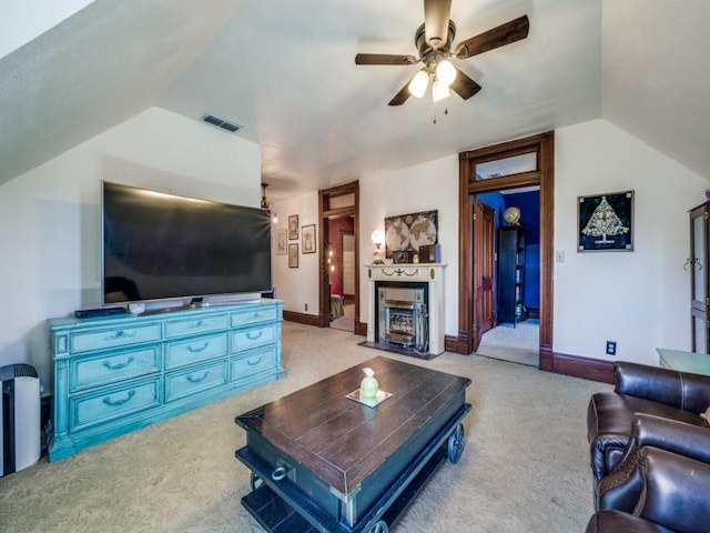 306 E Tarrant St, Bowie, TX 76230 - living room with lofted ceiling, light colored carpet, a ceiling fan, and a fireplace