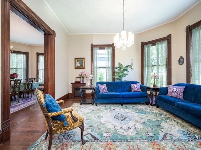 306 E Tarrant St, Bowie, TX 76230 - living room with a chandelier, dark wood finished floors, crown molding, and baseboards