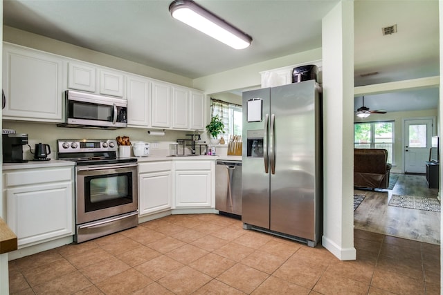 226 Merlin Dr, Weatherford, TX 76086 - kitchen with appliances with stainless steel finishes, healthy amount of natural light, white cabinetry, and light countertops