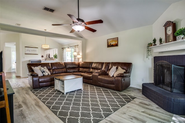 226 Merlin Dr, Weatherford, TX 76086 - living room with vaulted ceiling, wood finished floors, a ceiling fan, and a fireplace