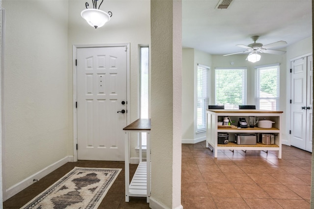 226 Merlin Dr, Weatherford, TX 76086 - entrance foyer featuring a ceiling fan, a textured wall, tile patterned flooring, and baseboards