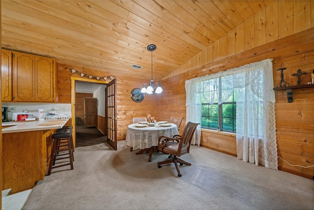 225 Springwood Cir, Chandler, TX 75758 - dining area with vaulted ceiling, wooden walls, a chandelier, wood ceiling, and light carpet