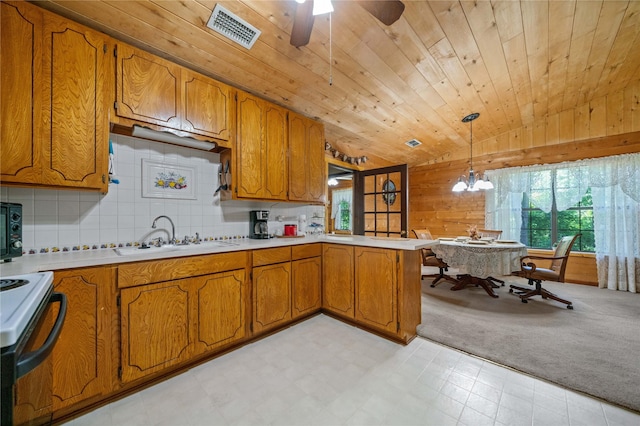225 Springwood Cir, Chandler, TX 75758 - kitchen featuring vaulted ceiling, brown cabinets, a sink, a peninsula, and light countertops