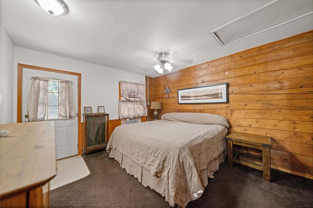 225 Springwood Cir, Chandler, TX 75758 - carpeted bedroom featuring attic access, wooden walls, and a ceiling fan