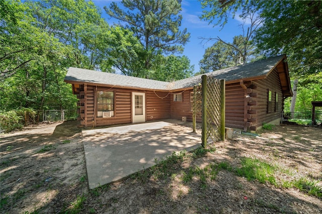 225 Springwood Cir, Chandler, TX 75758 - back of property with log siding and a patio area