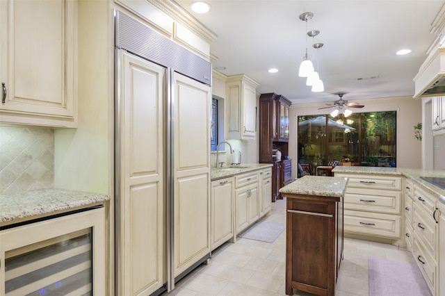 9208 Seagrove Dr, Dallas, TX 75243 - kitchen with beverage cooler, cream cabinets, decorative backsplash, a ceiling fan, and paneled built in fridge