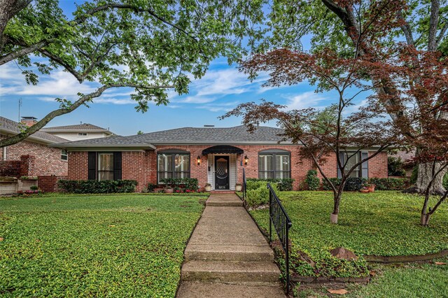 9208 Seagrove Dr, Dallas, TX 75243 - view of front of house with brick siding, a front lawn, and roof with shingles