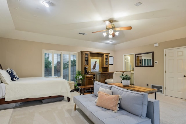 9208 Seagrove Dr, Dallas, TX 75243 - bedroom with light colored carpet, a ceiling fan, and a tray ceiling