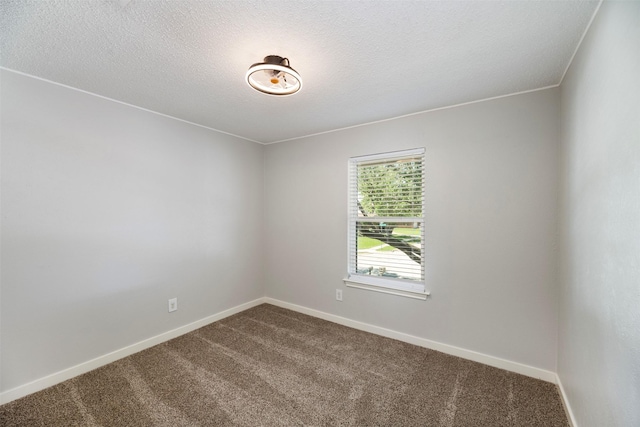 1606 Clarendon Dr, Lewisville, TX 75067 - unfurnished room featuring dark colored carpet, baseboards, and a textured ceiling