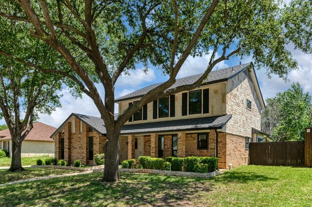 1606 Clarendon Dr, Lewisville, TX 75067 - traditional-style house featuring brick siding and roof with shingles