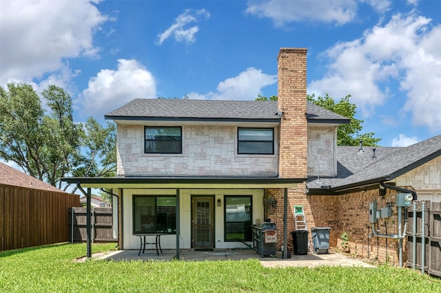 1606 Clarendon Dr, Lewisville, TX 75067 - rear view of house featuring a patio, roof with shingles, stone siding, and a chimney
