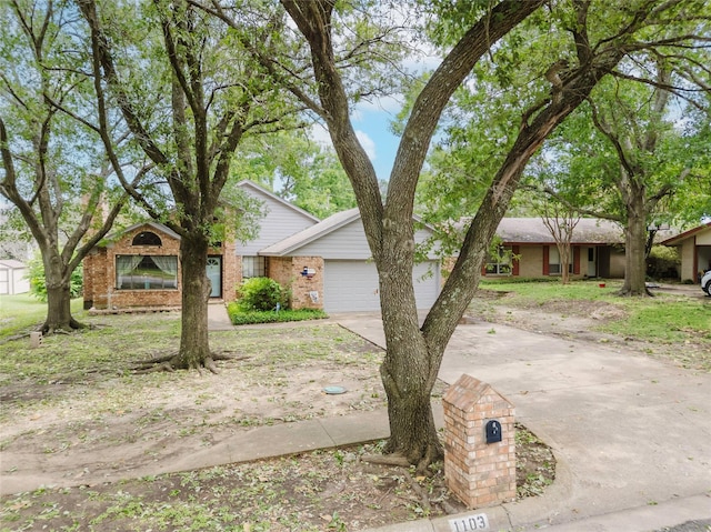 1103 Bluebonnet Hill Dr, Ennis, TX 75119 - view of front of property featuring concrete driveway, brick siding, and an attached garage