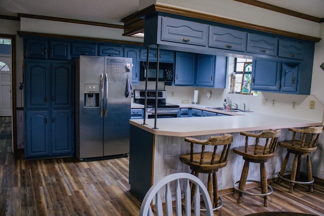 1103 Bluebonnet Hill Dr, Ennis, TX 75119 - kitchen with appliances with stainless steel finishes, a peninsula, blue cabinets, and a sink