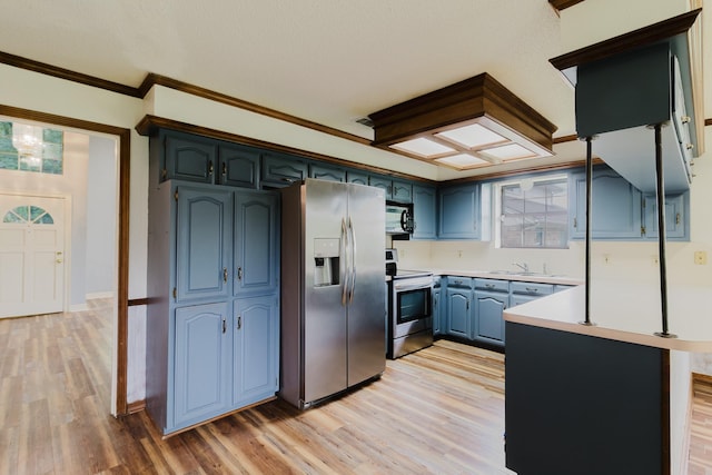 1103 Bluebonnet Hill Dr, Ennis, TX 75119 - kitchen featuring appliances with stainless steel finishes, blue cabinets, light countertops, light wood-style flooring, and crown molding