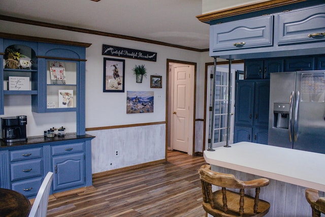 1103 Bluebonnet Hill Dr, Ennis, TX 75119 - kitchen featuring stainless steel fridge with ice dispenser, blue cabinetry, ornamental molding, dark wood finished floors, and a kitchen bar
