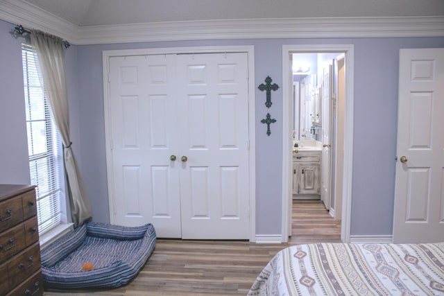 1103 Bluebonnet Hill Dr, Ennis, TX 75119 - bedroom with wood finished floors, a closet, crown molding, and connected bathroom