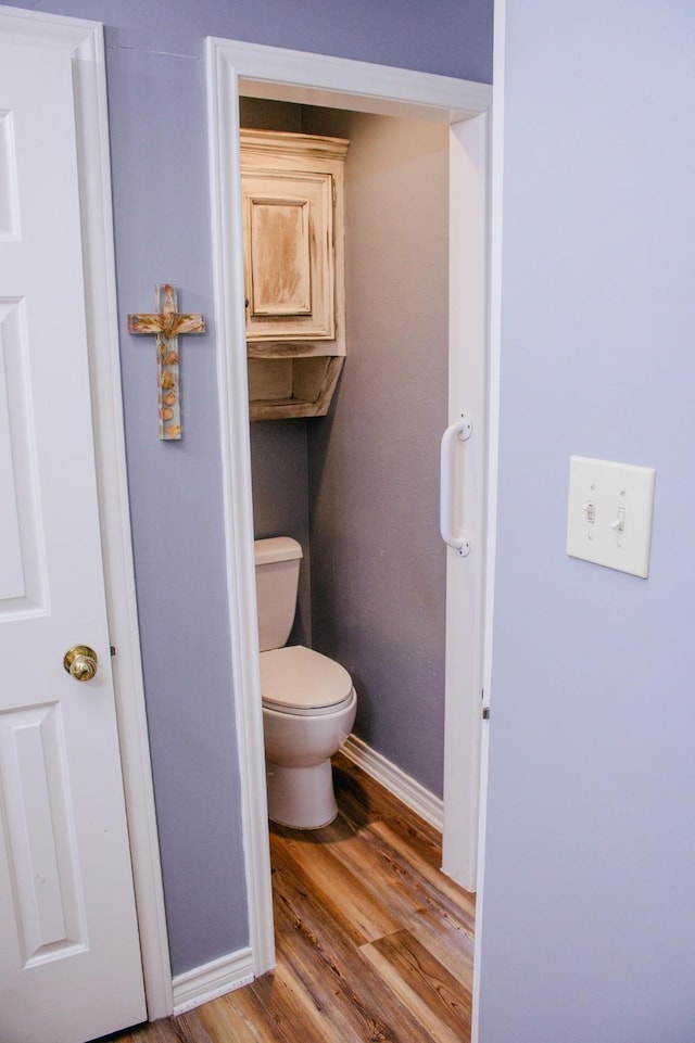 1103 Bluebonnet Hill Dr, Ennis, TX 75119 - bathroom with baseboards, toilet, and wood finished floors