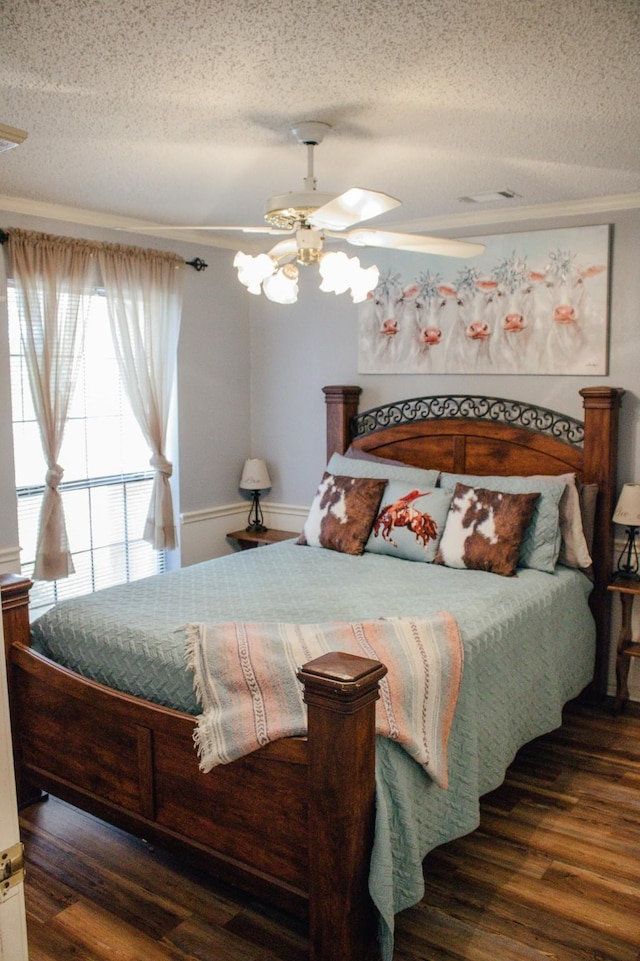1103 Bluebonnet Hill Dr, Ennis, TX 75119 - bedroom featuring a textured ceiling, wood finished floors, ceiling fan, ornamental molding, and a chandelier