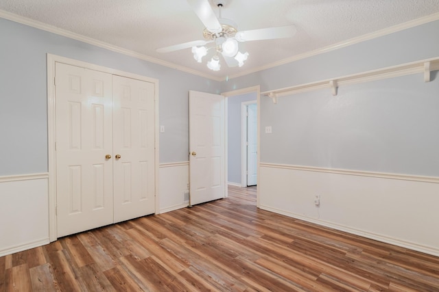1103 Bluebonnet Hill Dr, Ennis, TX 75119 - unfurnished bedroom featuring wood finished floors, a closet, a textured ceiling, ceiling fan, and crown molding