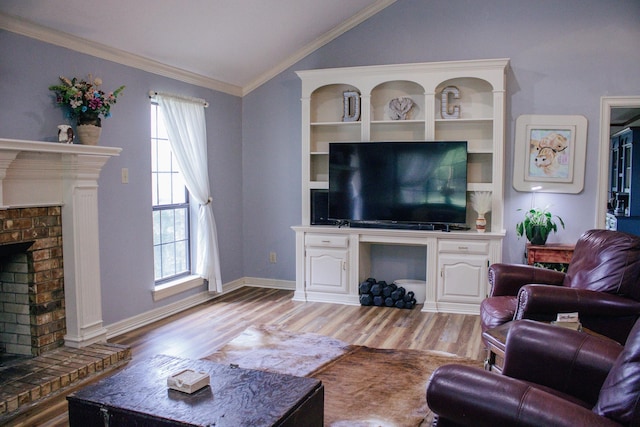 1103 Bluebonnet Hill Dr, Ennis, TX 75119 - living area with vaulted ceiling, a brick fireplace, crown molding, light wood-type flooring, and baseboards
