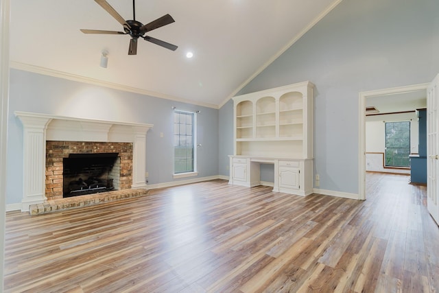 1103 Bluebonnet Hill Dr, Ennis, TX 75119 - unfurnished living room with high vaulted ceiling, a ceiling fan, light wood-style floors, a fireplace, and built in study area