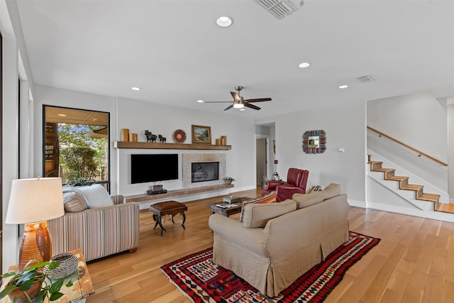 5120 Fairway Cir, Granbury, TX 76049 - living room with light wood finished floors, ceiling fan, stairway, a glass covered fireplace, and recessed lighting
