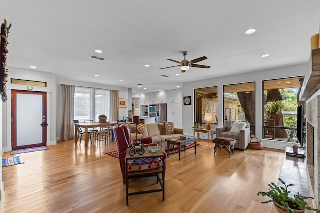5120 Fairway Cir, Granbury, TX 76049 - living area with light wood-style floors, ceiling fan, a fireplace, baseboards, and recessed lighting
