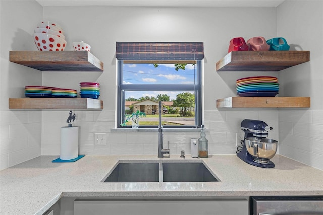 5120 Fairway Cir, Granbury, TX 76049 - kitchen with open shelves, a sink, tasteful backsplash, dishwasher, and light stone countertops