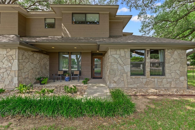 5120 Fairway Cir, Granbury, TX 76049 - back of property with stone siding, covered porch, and roof with shingles