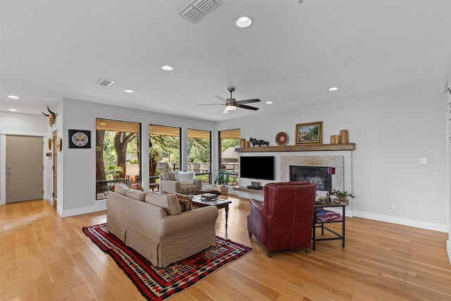 5120 Fairway Cir, Granbury, TX 76049 - living room featuring ceiling fan, light wood-style floors, a glass covered fireplace, baseboards, and recessed lighting