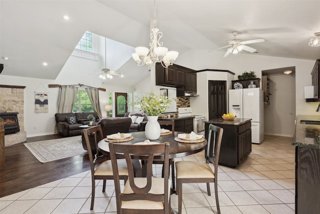1000 Ballard Rd, Van Alstyne, TX 75495 - dining area with ceiling fan, light tile patterned floors, baseboards, a chandelier, and high vaulted ceiling