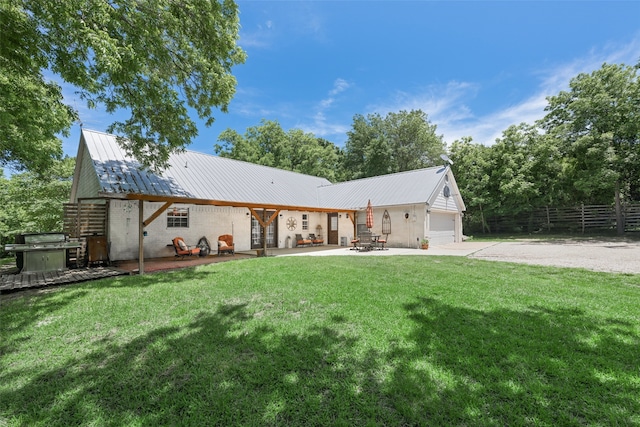 1000 Ballard Rd, Van Alstyne, TX 75495 - rear view of house featuring concrete driveway, metal roof, an attached garage, and a patio