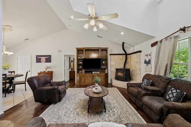 1000 Ballard Rd, Van Alstyne, TX 75495 - living room featuring high vaulted ceiling, wood finished floors, a wood stove, a ceiling fan, and a chandelier