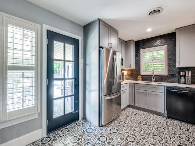 879 Peavy Rd, Dallas, TX 75218 - kitchen featuring black dishwasher, freestanding refrigerator, gray cabinets, and a sink