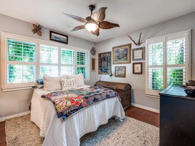 879 Peavy Rd, Dallas, TX 75218 - bedroom featuring multiple windows, baseboards, wood finished floors, and ceiling fan