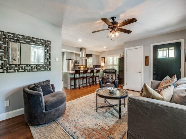 879 Peavy Rd, Dallas, TX 75218 - living room with ceiling fan, wood finished floors, baseboards, and healthy amount of natural light