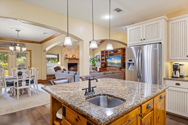 1096 Black Hawk Trl, Nemo, TX 76070 - kitchen with stainless steel fridge, a sink, dark wood finished floors, dark stone counters, and crown molding