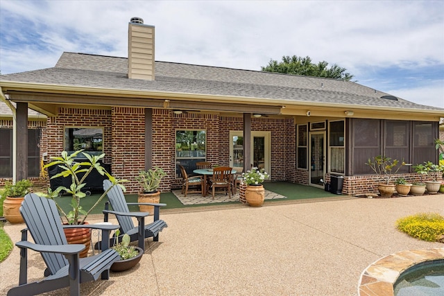 1096 Black Hawk Trl, Nemo, TX 76070 - rear view of house featuring brick siding, a patio, a chimney, outdoor dining area, and a shingled roof