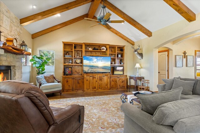 1096 Black Hawk Trl, Nemo, TX 76070 - living area with arched walkways, light wood-style floors, beam ceiling, ceiling fan, and a fireplace