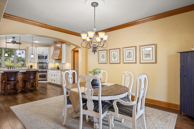 1096 Black Hawk Trl, Nemo, TX 76070 - dining room with arched walkways, crown molding, a chandelier, dark wood-type flooring, and ceiling fan
