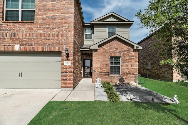 2211 Barrow St, Princeton, TX 75407 - view of front facade with a front yard, brick siding, a garage, and concrete driveway