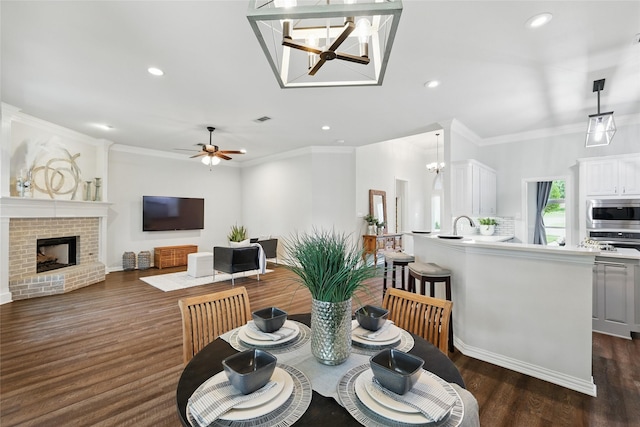 1137 Countryhill Dr, Keller, TX 76248 - dining space with recessed lighting, dark wood finished floors, a brick fireplace, a chandelier, and ceiling fan