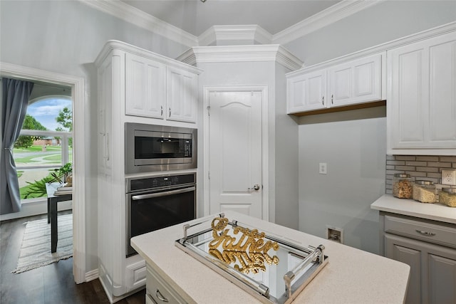 1137 Countryhill Dr, Keller, TX 76248 - kitchen with stainless steel appliances, white cabinets, light countertops, crown molding, and decorative backsplash