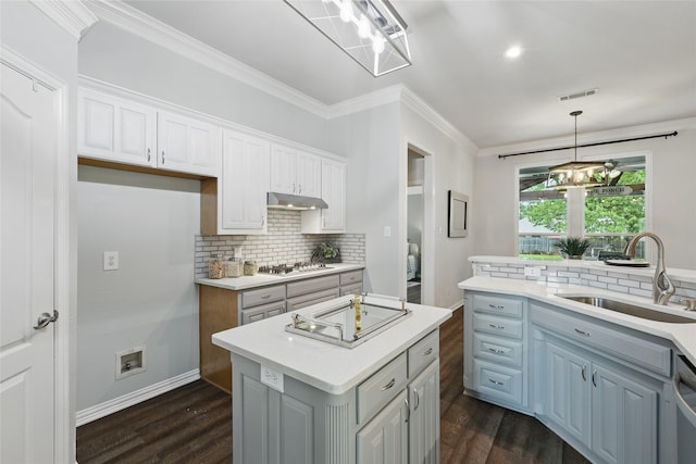 1137 Countryhill Dr, Keller, TX 76248 - kitchen with under cabinet range hood, a sink, electric stovetop, backsplash, and crown molding
