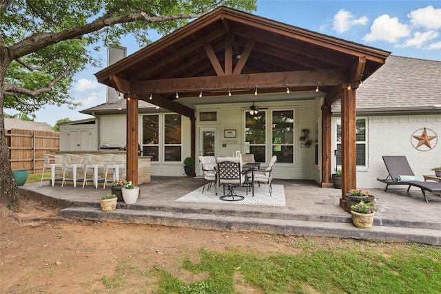 1137 Countryhill Dr, Keller, TX 76248 - rear view of house featuring a patio, a ceiling fan, a chimney, brick siding, and roof with shingles