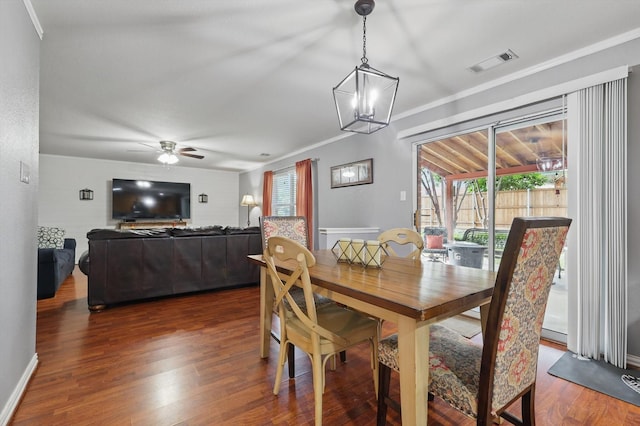 1500 Caymus Ct, Lewisville, TX 75067 - dining room featuring dark wood-style flooring, ceiling fan, crown molding, a chandelier, and baseboards