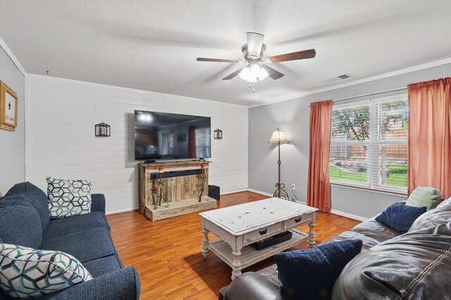 1500 Caymus Ct, Lewisville, TX 75067 - living area with a ceiling fan, wood finished floors, wooden walls, ornamental molding, and baseboards