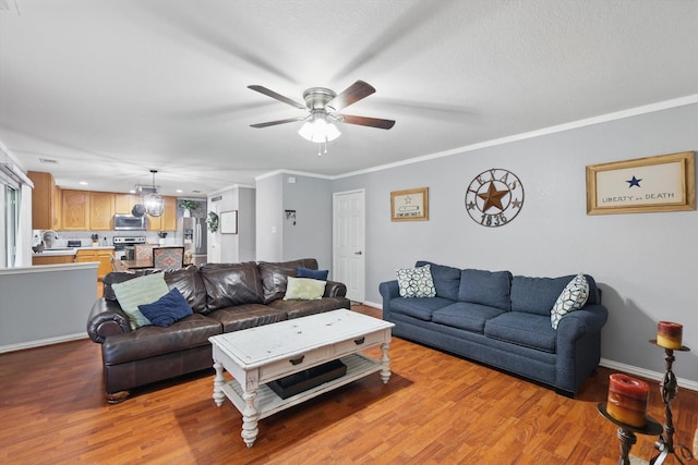 1500 Caymus Ct, Lewisville, TX 75067 - living room featuring light wood-type flooring, ceiling fan, baseboards, crown molding, and recessed lighting