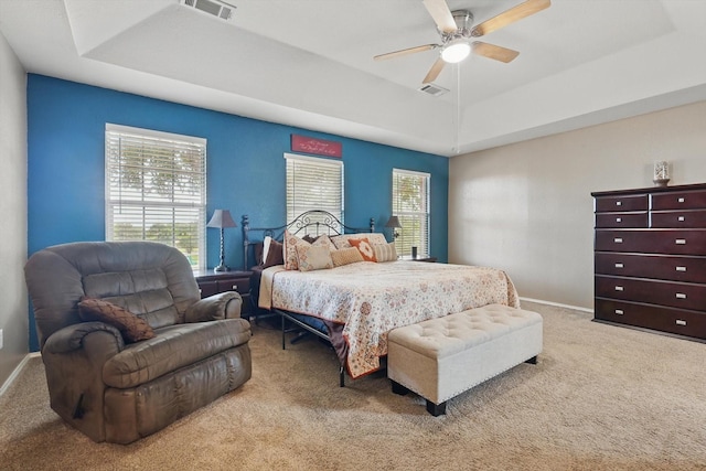 1500 Caymus Ct, Lewisville, TX 75067 - carpeted bedroom featuring a tray ceiling, baseboards, and ceiling fan