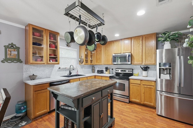 1500 Caymus Ct, Lewisville, TX 75067 - kitchen with stainless steel appliances, a sink, tasteful backsplash, open shelves, and light wood-type flooring